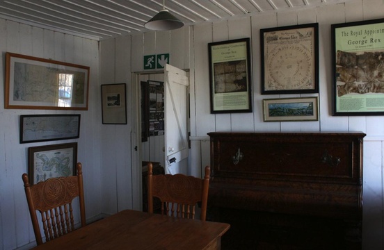 Reading room in Millwood House at the Knysna Museum. Royal appointment of George Rex on the right
